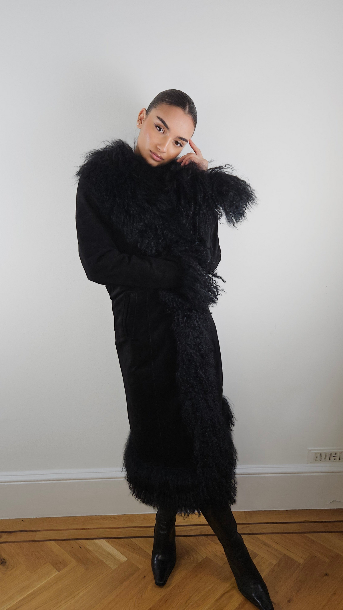 Shalah coat by Aql&Nafs in black suede with Mongolian shearling at collar, cuffs and hem