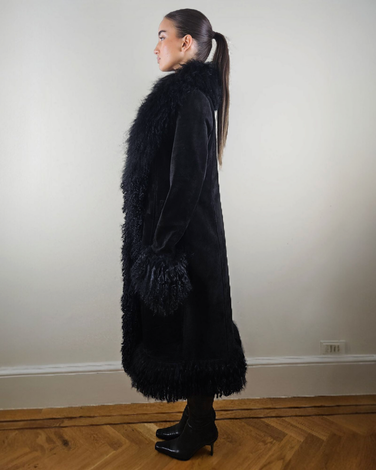 Shalah coat by Aql&Nafs in black suede with Mongolian shearling at collar, cuffs and hem