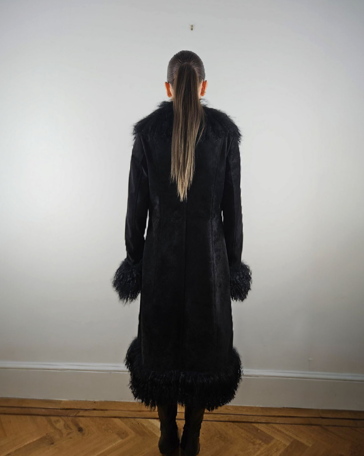 Shalah coat by Aql&Nafs in black suede with Mongolian shearling at collar, cuffs and hem